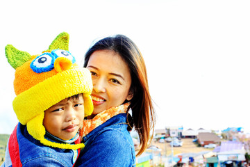 Family activity outdoors. Cheerful young mom and little child pl