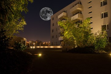 night scene of city and big moon on the sky