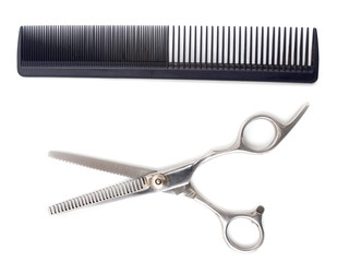 Comb with scissors on a white background