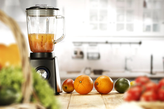 Background of wooden table with free space for your decoration of product or text. Blurred vegetables and fruits in the foreground image. Closeup of slim yound woman body and blender with juice. 