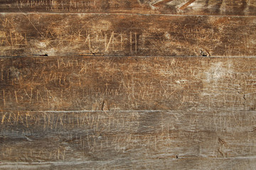 Old wooden fence with words engraving.