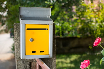 Yellow mailbox in front of the house
