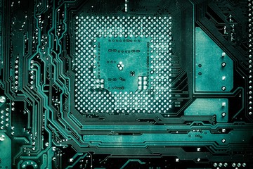 Abstract aged green computer circuit board close up for background.