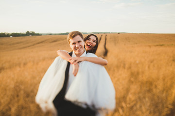 happy and young bride and groom having fun together