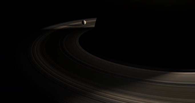 Animation of moon or satellite rotating through the rings of the planet Saturn