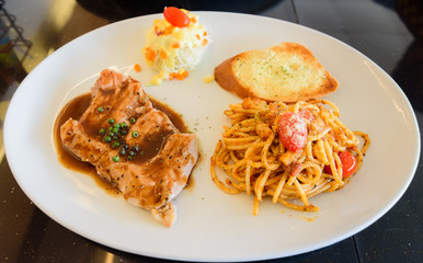 Dish of bread spaghetti with pork steak