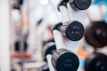 many dumbbells are at stand at the gym