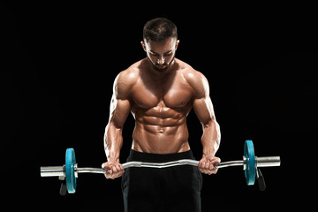 Fototapeta na wymiar muscular man lifting weights over dark background