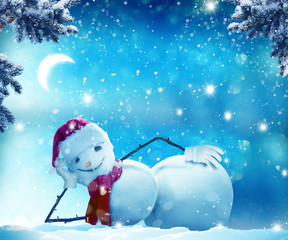 Merry Christmas and happy New Year greeting card with copy-space.Funny snowman lying in the snow.
