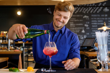Barman preparing alcoholic cocktail for customer