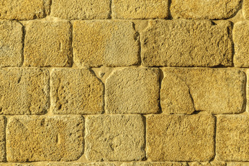 masonry wall with ashlars gilded by the light of the evening in Oporto, Portugal