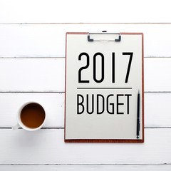 2017 budget on on clipboard over white wood background