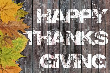 Happy Thanksgiving written on wooden background