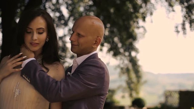 Devine woman enjoys man's touch standing on backyard