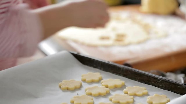 woman preparing christmas sugar cookies in the kitchen