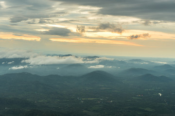 Fototapeta premium Mountain valley under mist and sunshine in the morning.
