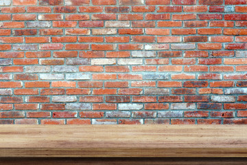 Empty wooden table over brick wall  background