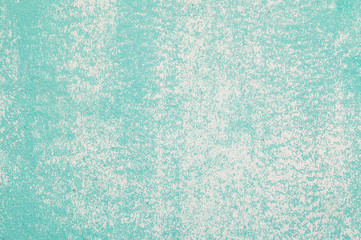 Closeup pale color and peeling of painted green cement wall textured background