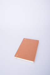 notebook or brown cover notebooks on the blackground.