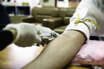 Nurse collecting a blood from a patient