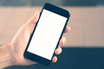 Woman hand hold black smartphone blank white screen for advertising display