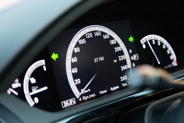 Luxury car interior. Electronic LCD display with speedometer and other indication. Text on russian