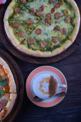 Coffee and pizza on a wooden table