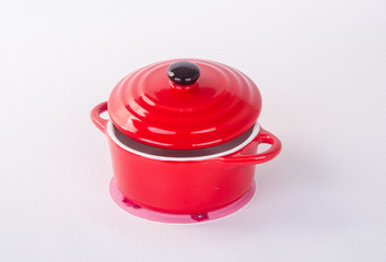 pot or red pot with cover on background.