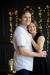 Young married couple stand gently having embraced.