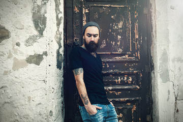 Portrait of brutal bearded man wearing blank t-shirt