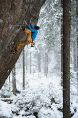 Unique winter sports. Rock climber on a challenging ascent. Extreeme climbing. 
