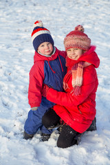 Fototapeta na wymiar Two happy kids in winter clothes outdoor