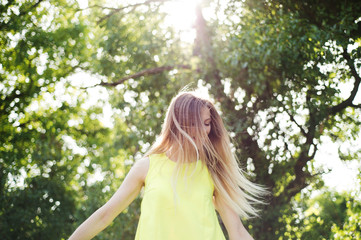 Beautiful young woman with long blonde hair. Sunny summer.