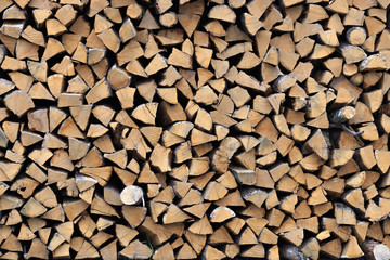 chopped firewood stacked for storage for the winter. background texture