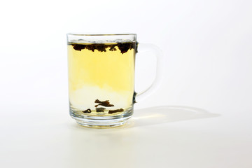 transparent cup of tea with custard on white background
