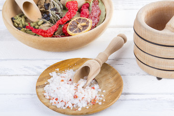 Spices wooden plate spoon spatula white vintage wooden background
