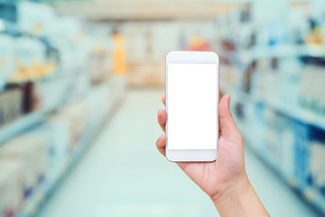 hand hold mobile phone with electronic store in supermarket