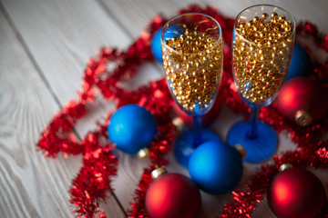 Serving Table. new years eve party table with champagne. Champagne glasses. Celebration theme. New dekor- beads, garland instead of champagne. Festive glasses with champagne.