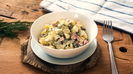 bowl of traditional russian salad on wooden table
