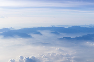 Fototapeta premium Blue sky and mountains view from airplane stylized hipster background with copyspace