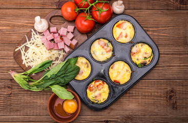 Delicious egg muffins with ham, cheese and vegetables. Concept of cooking.