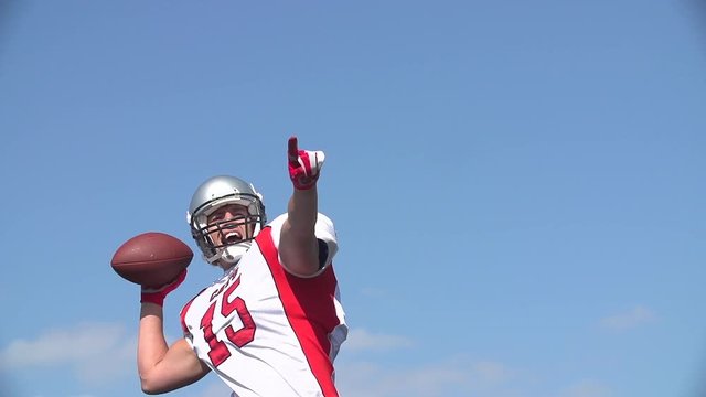 Quarterback looks and shouts to throw ball.