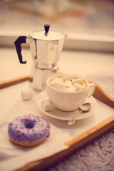 Warm cozy home. Tray and cup of coffee with marshmallows 