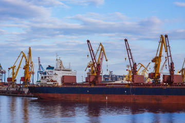 Obraz premium sea cargo terminal with ship, cranes and containers
