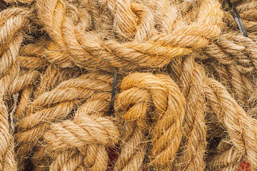 Thick rope of jute fiber tangled in the ground