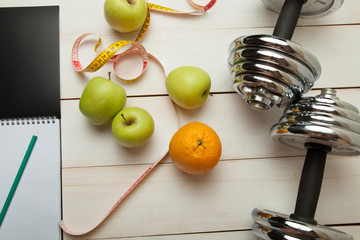 diet plan, menu or program, weight loss, measuring tape, dumbbells and dietary food fresh fruit