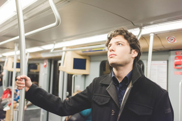 Young beautiful caucasian man commuter in the subway - commuting, journey, underground concept