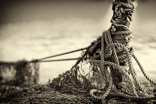 Tied Up Ship Rope On Norway Beach In Sepia