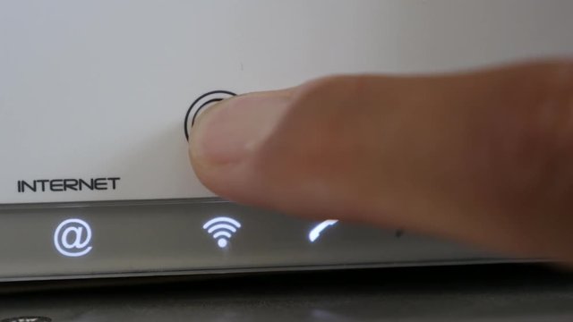 Finger pressing wireless device button 4K 2160p 30fps UltraHD footage - On white Internet router Wi-Fi signal turning OFF 3840X2160 UHD video