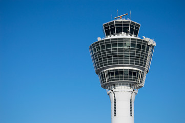 Modern air traffic control tower in international passenger airport over clear blue sky